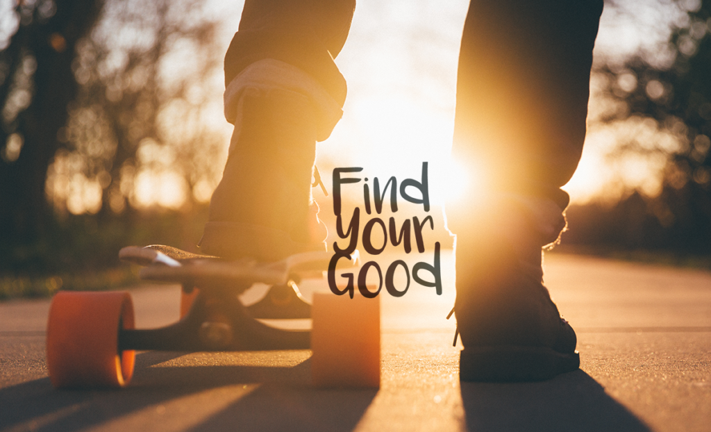 Picture of someone's legs and a skateboard as they are in the sunset. 